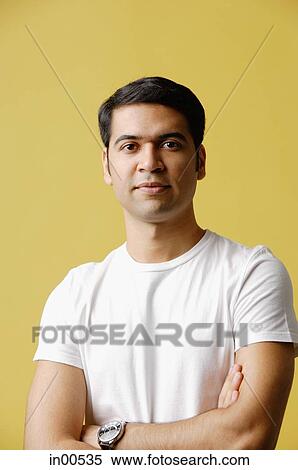 Man standing, arms crossed, looking at camera View Large Photo Image Stock Photography - Man standing, arms crossed, looking at camera. Fotosearch