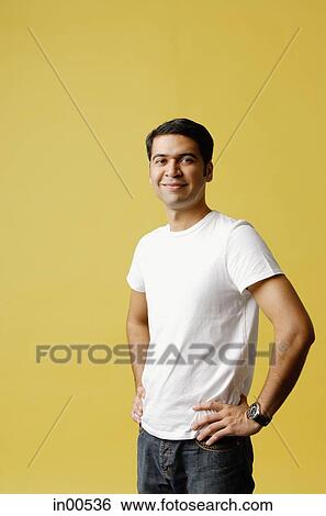 Man standing, hands on hips, looking at camera View Large Photo Image Stock Photograph - Man standing, hands on hips, looking at camera. Fotosearch