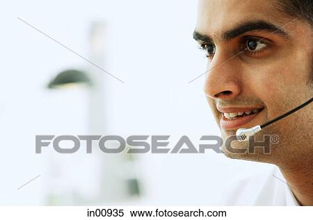 Man using headset, head shot View Large Photo Image Stock Photography - Man using headset, head shot. Fotosearch