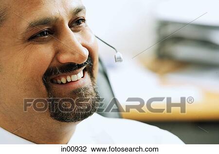 Man using headset, smiling View Large Photo Image Stock Image - Man using headset, smiling. Fotosearch