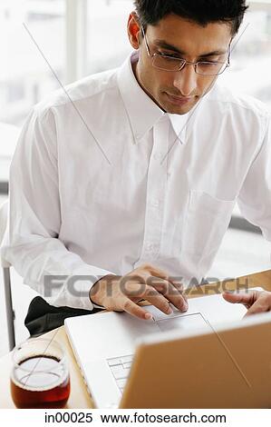 Man using laptop, high angle view View Large Photo Image Stock Photography - Man using laptop, high angle view. Fotosearch