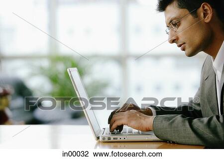 Man using laptop, sideview View Large Photo Image Stock Image - Man using laptop, sideview. Fotosearch