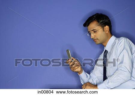 Man using mobile phone View Large Photo Image Picture - Man using mobile phone. Fotosearch
