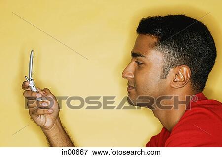 Man using mobile phone, text messaging View Large Photo Image Stock Photo - Man using mobile phone, text messaging. Fotosearch