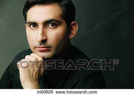 Stock Photograph - Man with hand on chin, portrait. Fotosearch