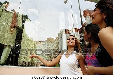 Three women window shopping View Large Photo Image Stock Photo - Three women window shopping. Fotosearch