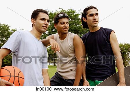 Three young men, looking away View Large Photo Image Stock Image - Three young men, looking away. Fotosearch