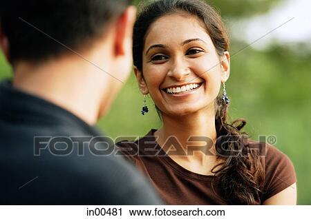 Woman facing man, smiling, over the shoulder view View Large Photo Image Stock Image - Woman facing man, smiling, over the shoulder view. Fotosearch