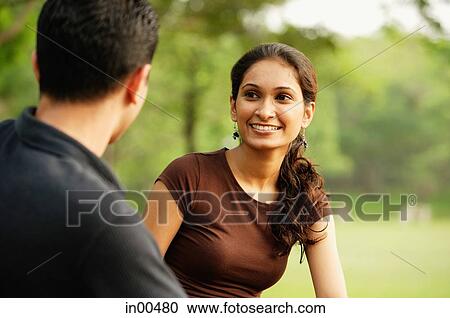 Woman facing man, smiling View Large Photo Image Stock Image - Woman facing man, smiling. Fotosearch