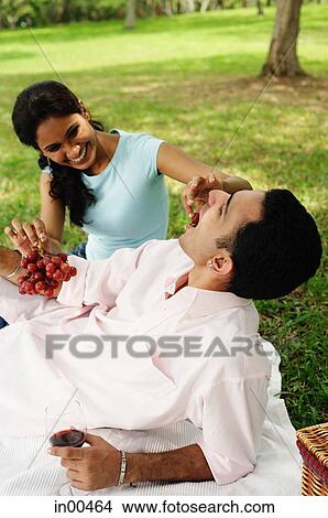 Woman feeding man grapes View Large Photo Image Picture - Woman feeding man grapes. Fotosearch