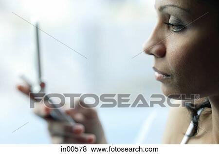 Woman holding mobile phone View Large Photo Image Stock Photo - Woman holding mobile phone. Fotosearch