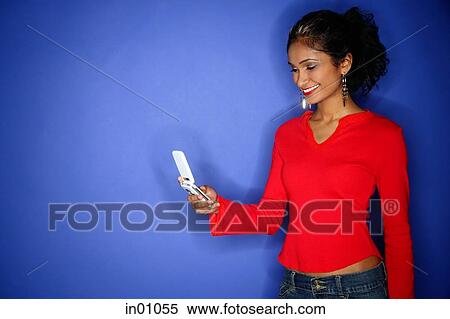 Woman holding mobile phone View Large Photo Image Stock Photography - Woman holding mobile phone. Fotosearch