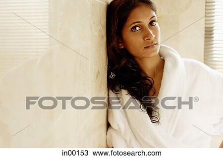 Woman in bathrobe, leaning on wall, looking at camera View Large Photo Image Stock Image - Woman in bathrobe, leaning on wall, looking at camera. Fotosearch