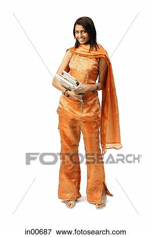 Stock Photo - Woman in Indian clothing, carrying books, looking at camera. Fotosearch