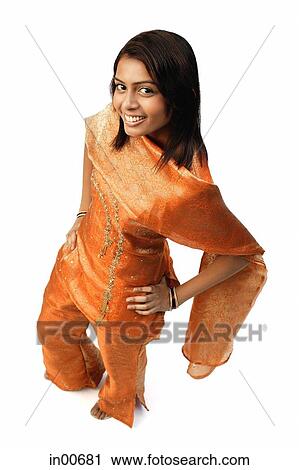 Woman in Indian clothing, hand on hip, smiling at camera View Large Photo Image Stock Image - Woman in Indian clothing, hand on hip, smiling at camera. Fotosearch