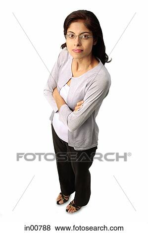 Stock Photo - Woman looking at camera, arms crossed. Fotosearch