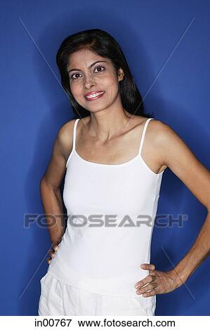 Stock Photo - Woman looking at camera, hand on hip. Fotosearch