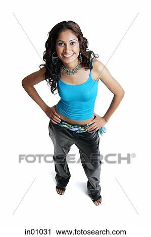 Stock Image - Woman looking at camera, hands on hips. Fotosearch