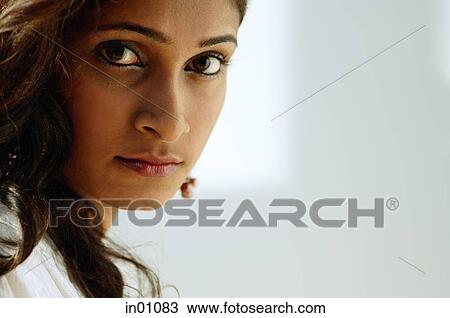 Woman looking at camera, head shot View Large Photo Image Stock Image - Woman looking at camera, head shot. Fotosearch