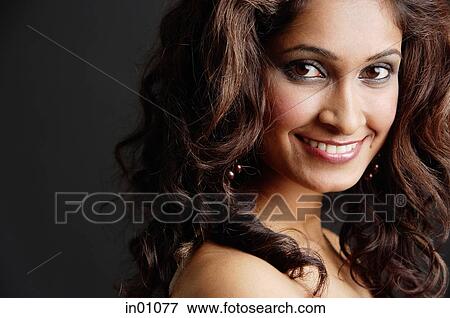 Stock Photo - Woman looking at camera, head shot. Fotosearch