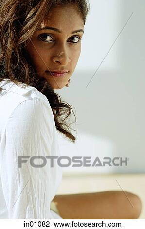 Stock Image - Woman looking at camera, portrait. Fotosearch