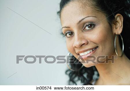 Woman looking at camera, smiling View Large Photo Image Picture - Woman looking at camera, smiling. Fotosearch