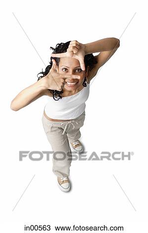 Woman looking at camera through hands View Large Photo Image Stock Image - Woman looking at camera through hands. Fotosearch
