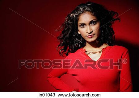 Woman looking at camera, wearing red blouse against red background View Large Photo Image Stock Image - Woman looking at camera, wearing red blouse against red background. Fotosearch