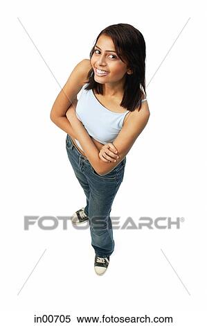 Stock Photography - Woman looking up at camera, arms crossed. Fotosearch