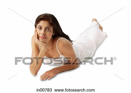 Woman lying on front, hand on chin View Large Photo Image Stock Image - Woman lying on front, hand on chin. Fotosearch