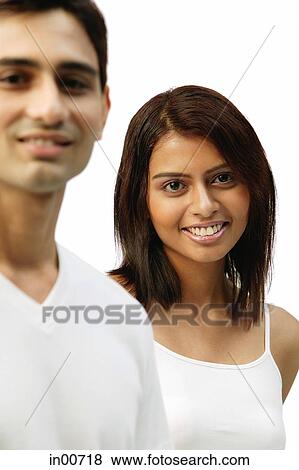 Stock Photo - Woman smiling at camera, man in foreground. Fotosearch