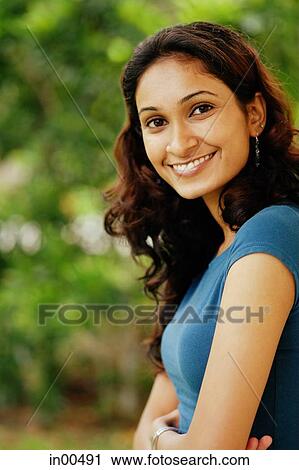 Stock Image - Woman smiling at camera, portrait. Fotosearch