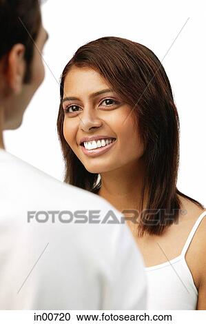 Stock Image - Woman smiling at man in front of her. Fotosearch