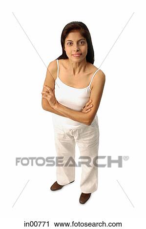 Woman standing, arms crossed, looking at camera View Large Photo Image Stock Image - Woman standing, arms crossed, looking at camera. Fotosearch
