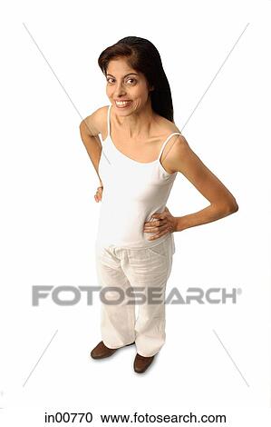 Stock Image - Woman standing, looking at camera. Fotosearch
