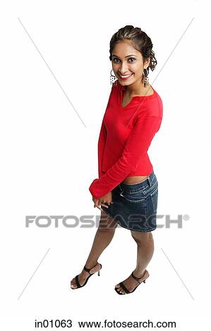 Stock Image - Woman standing, looking at camera. Fotosearch