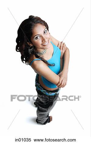 Stock Photography - Woman standing, smiling at camera, arms crossed. Fotosearch
