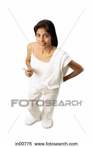 Woman standing, towel on shoulder, holding toothbrush View Large Photo Image Stock Photography - Woman standing, towel on shoulder, holding toothbrush. Fotosearch