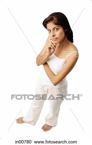 Woman standing with hand on chin, looking up at camera View Large Photo Image Stock Image - Woman standing with hand on chin, looking up at camera. Fotosearch