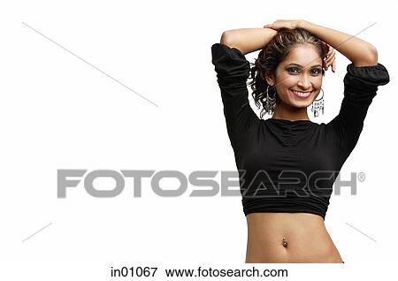 Woman standing with hands on head, smiling at camera View Large Photo Image Stock Photo - Woman standing with hands on head, smiling at camera. Fotosearch