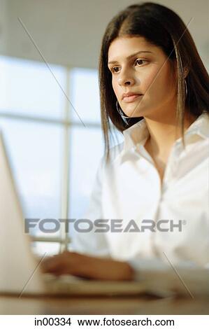 Picture - Woman using laptop. Fotosearch