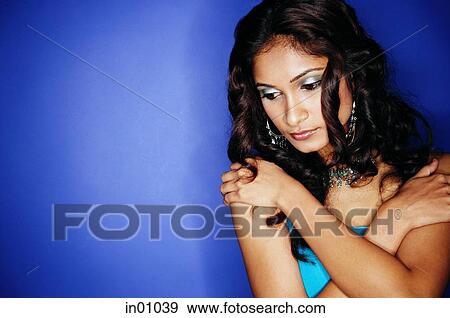 Woman with arms crossed over chest, looking down View Large Photo Image Stock Photo - Woman with arms crossed over chest, looking down. Fotosearch