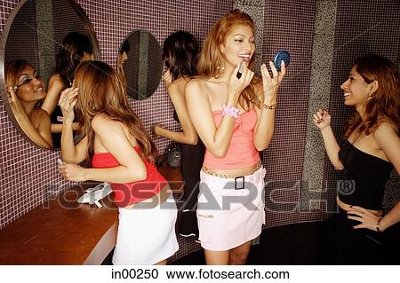 Women applying make-up in bathroom View Large Photo Image Stock Image - Women applying make-up in bathroom. Fotosearch