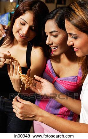 Women in shop looking at jewellery View Large Photo Image Stock Photo - Women in shop looking at jewellery. Fotosearch