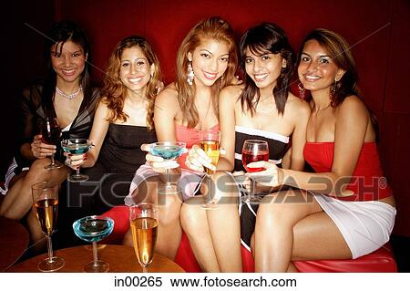 Women sitting side by side, smiling at camera View Large Photo Image Stock Photography - Women sitting side by side, smiling at camera. Fotosearch