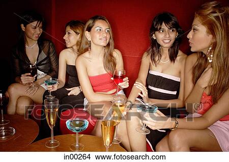 Picture - Women sitting side by side, talking. Fotosearch
