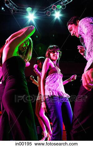 Young adults dancing in club View Large Photo Image Stock Photography - Young adults dancing in club. Fotosearch