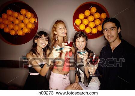 Young adults holding drinks out towards camera View Large Photo Image Stock Image - Young adults holding drinks out towards camera. Fotosearch