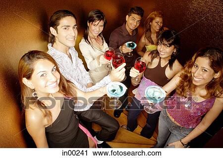 Young adults raising drinks to camera View Large Photo Image Stock Image - Young adults raising drinks to camera. Fotosearch