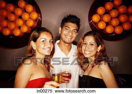 Stock Photography - Young adults smiling at camera, portrait. Fotosearch